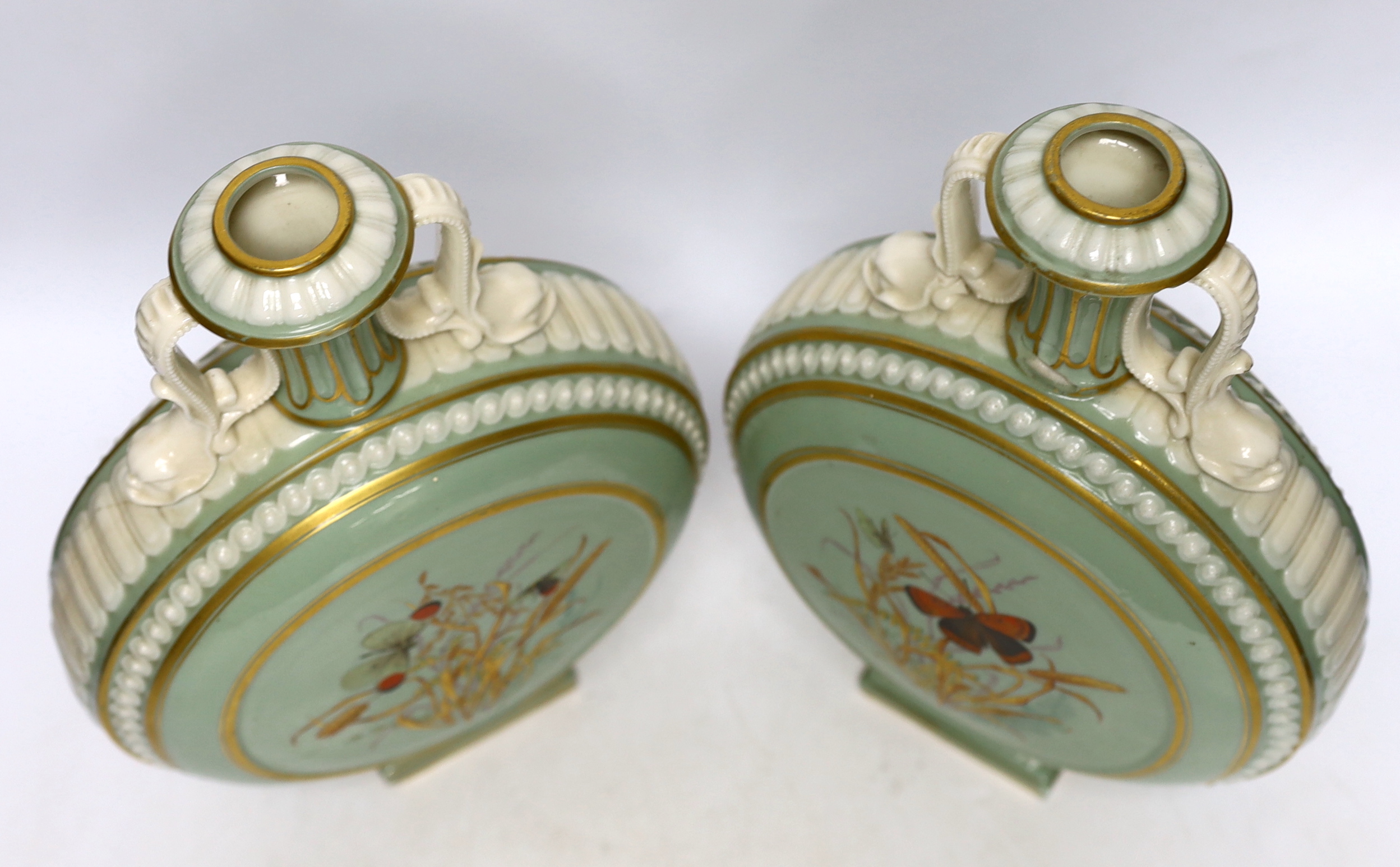 A pair of 19th century Continental moonflasks, decorated in relief and hand painted with butterflies, 28cm high